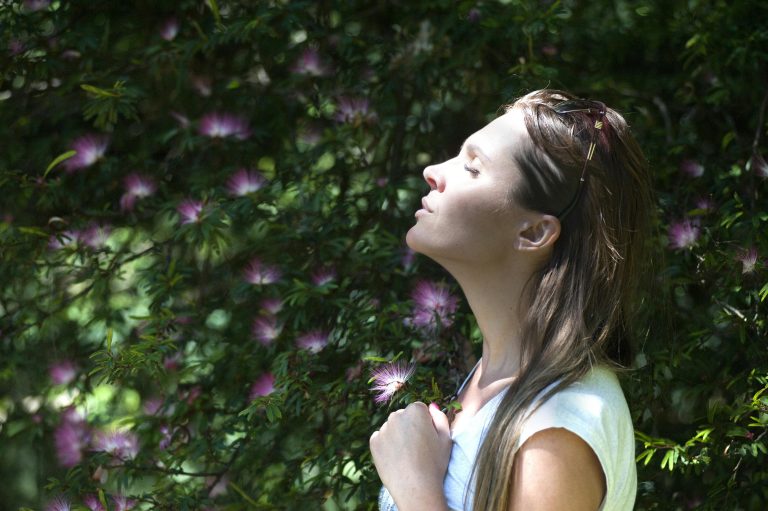 A woman with long hair with closed eyes in meditation
