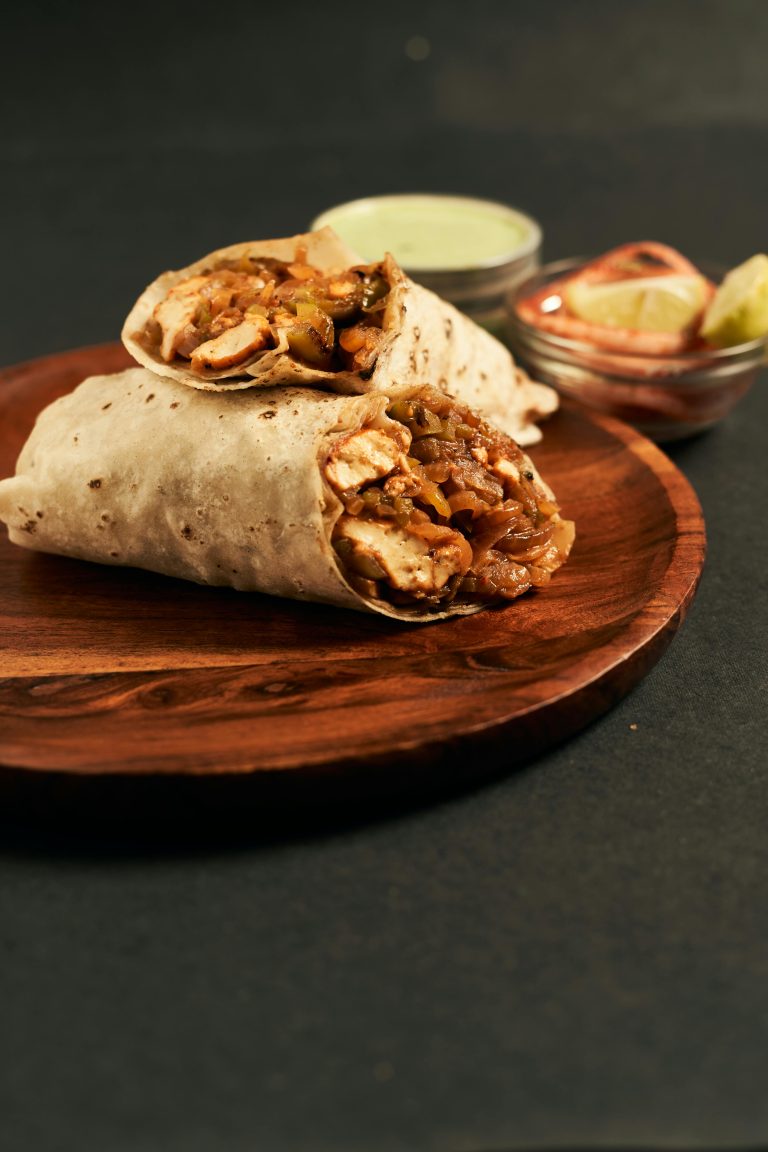 a picture of 2 half wraps filled with chicken and vegetables