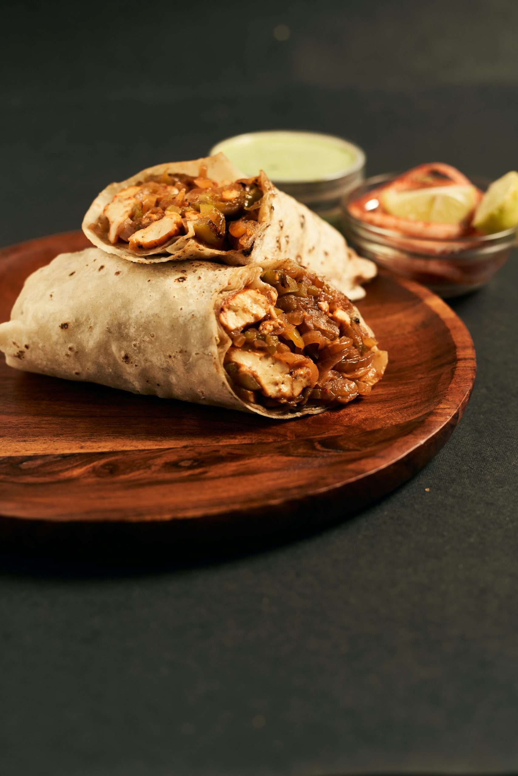 a picture of 2 half wraps filled with chicken and vegetables